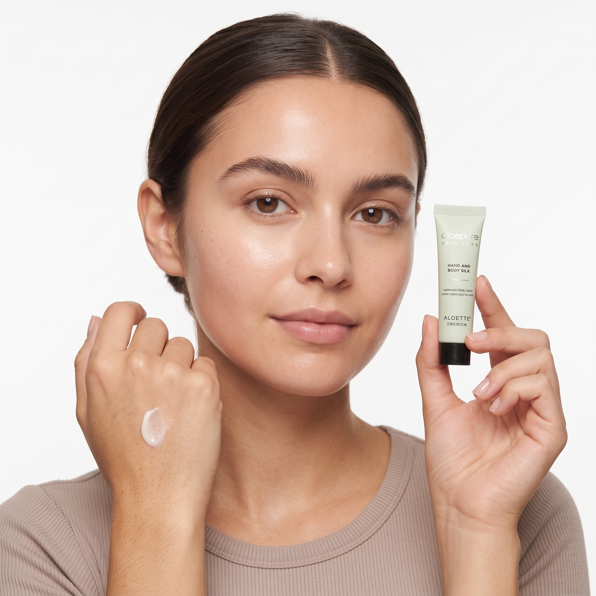 Who should try Aloette Hand & Body Silk Lotion — model holding the mini tube with lotion on her hand