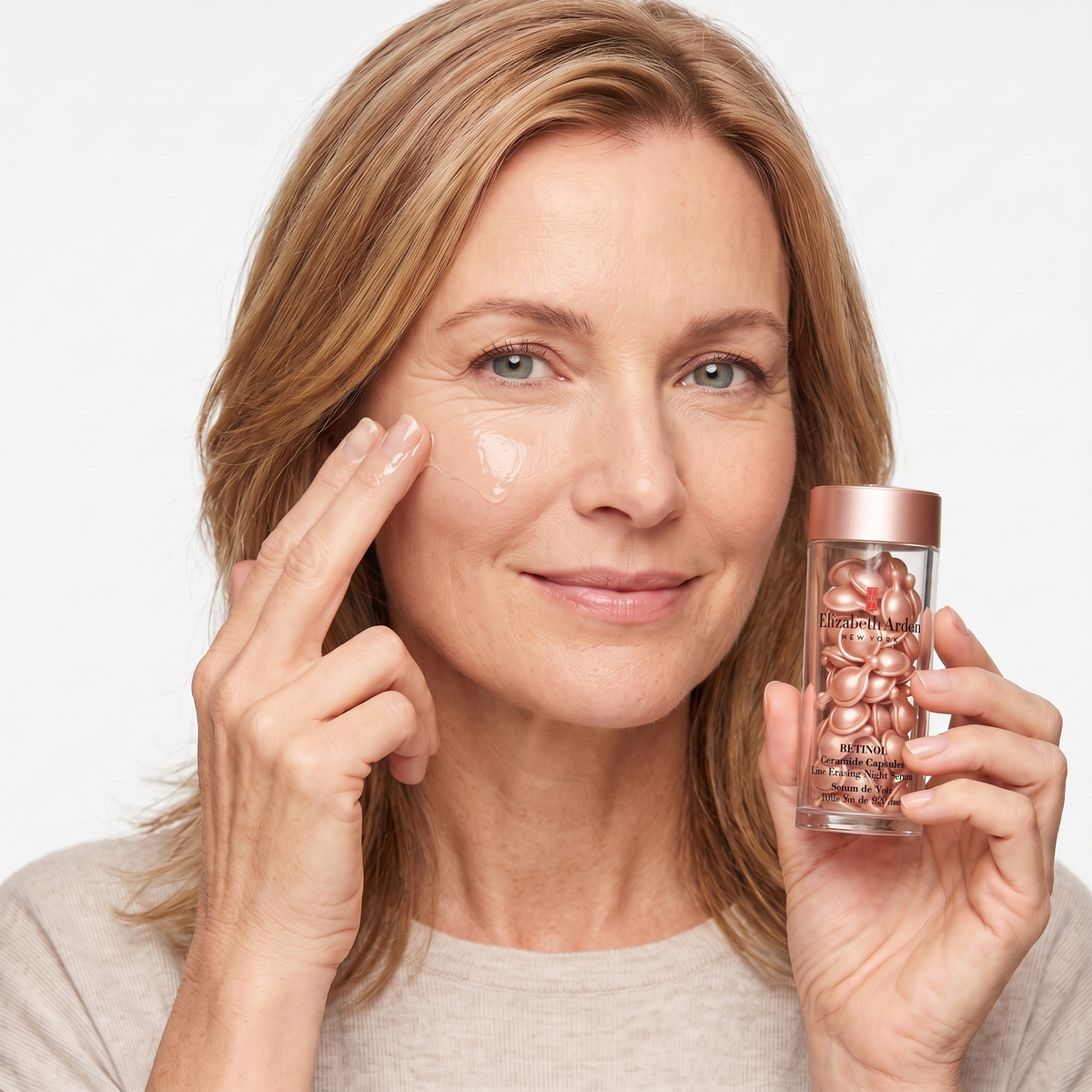 Who should try Elizabeth Arden Retinol Ceramide Capsules — mature model pressing serum into her cheek