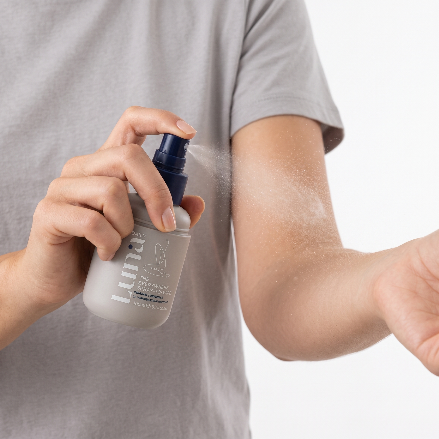 Woman spraying Luna Daily Everywhere Spray-to-Wipe on her forearm — Who should try these GOODS