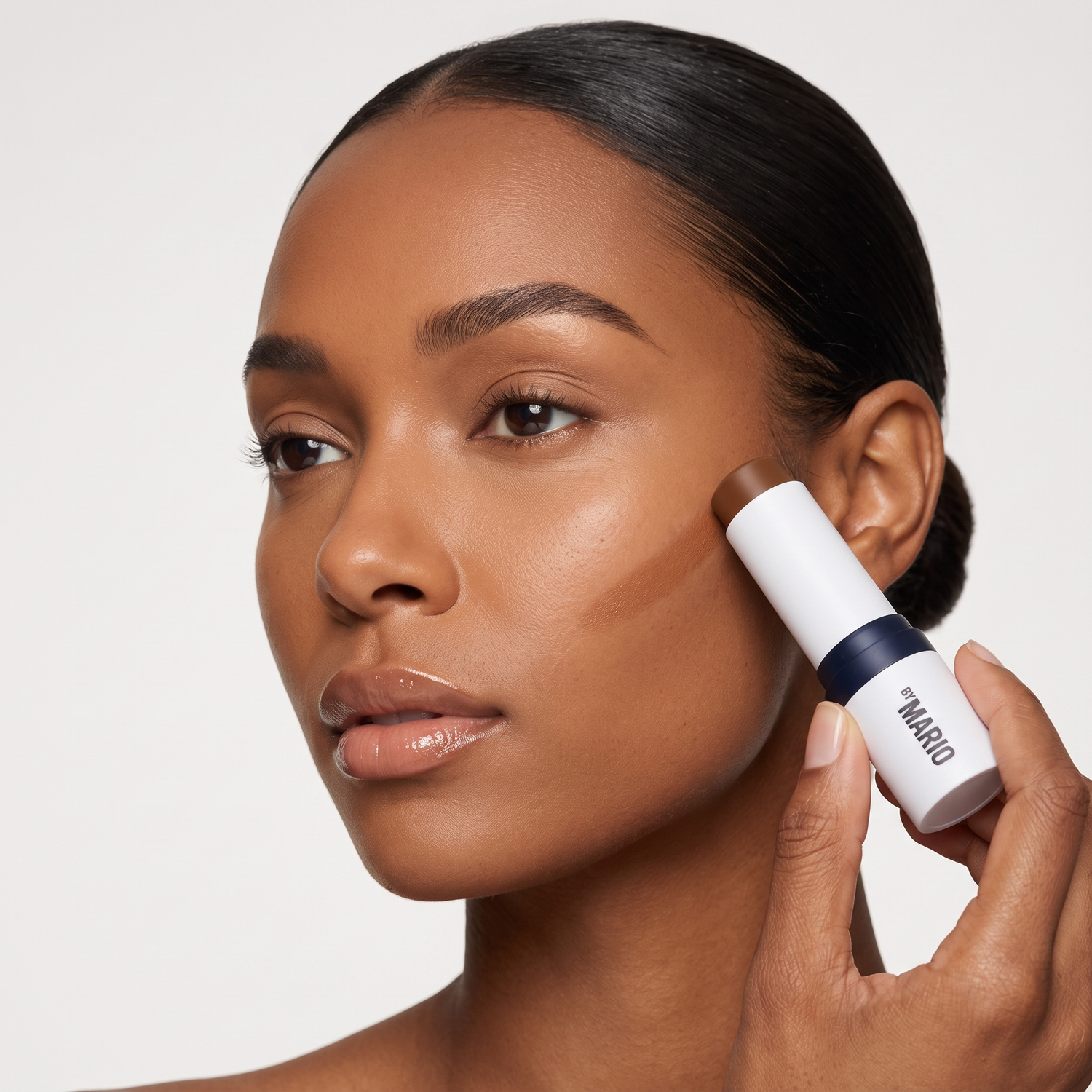 Model applying Makeup by Mario SoftSculpt contour stick in Dark — Who should try these GOODS