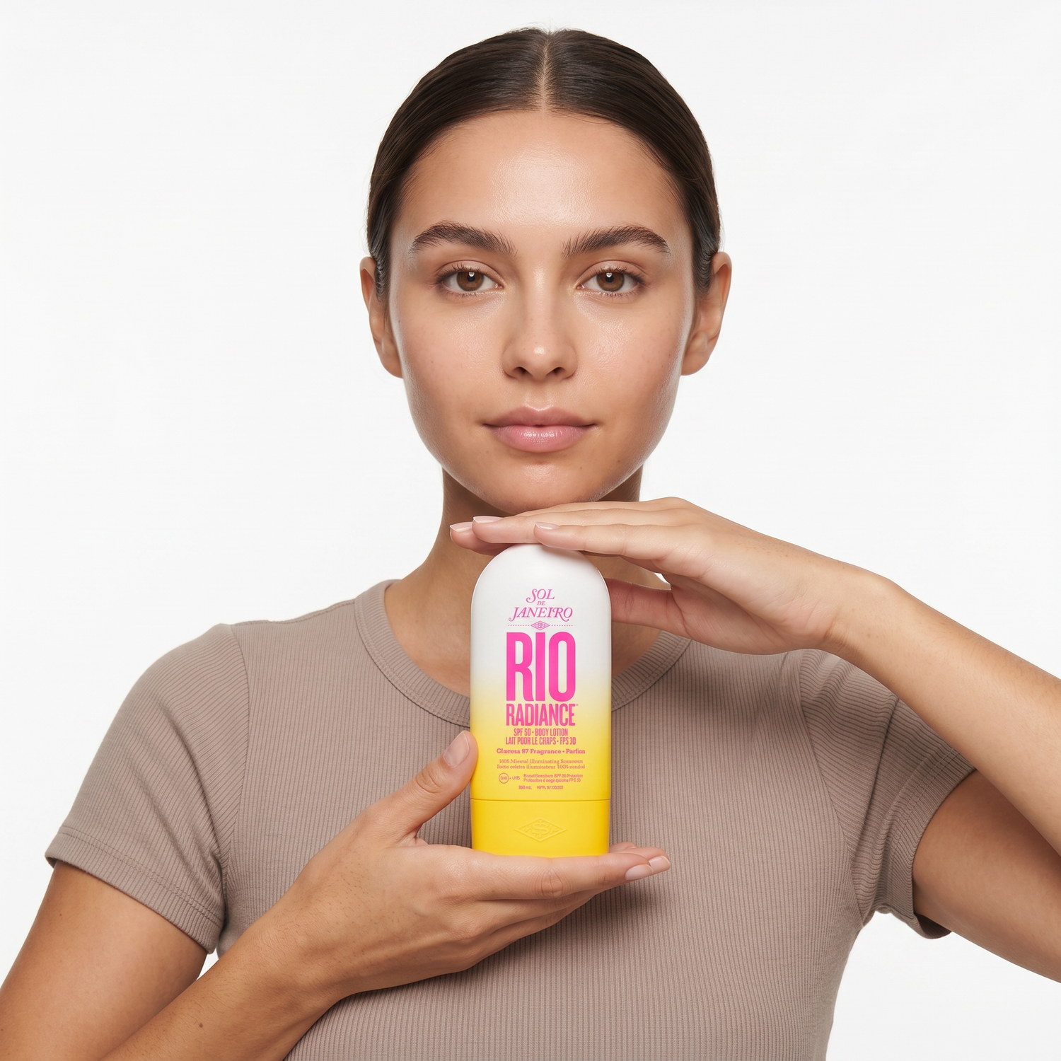 Who should try Sol de Janeiro Rio Radiance Body Lotion SPF 50 — model holding the Rio Radiance bottle