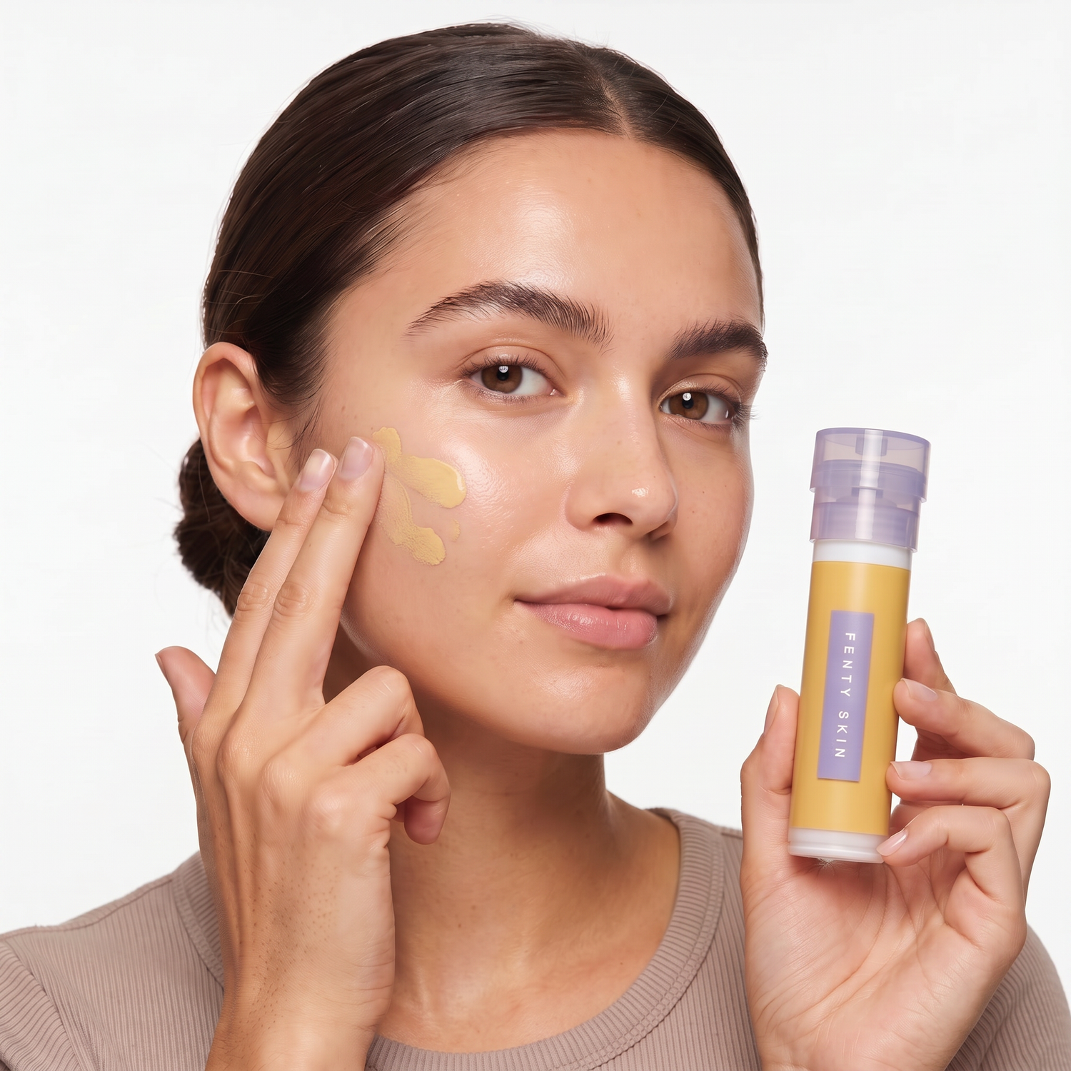 Who should try Fenty Skin Hydra Vizor Tinted Moisturizer SPF 30 — model blending the tinted moisturizer