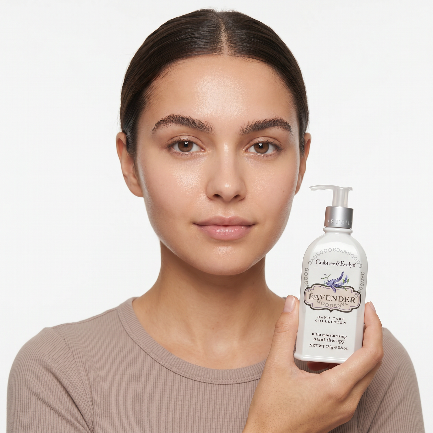 Who should try Crabtree & Evelyn Lavender Hand Therapy — model holding the pump bottle