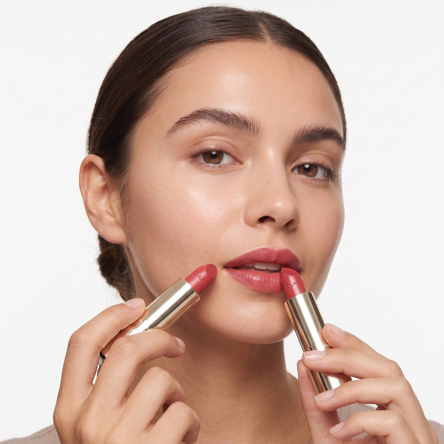 Who should try Clarins Joli Rouge Lipstick — model applying satin rose-red lipstick
