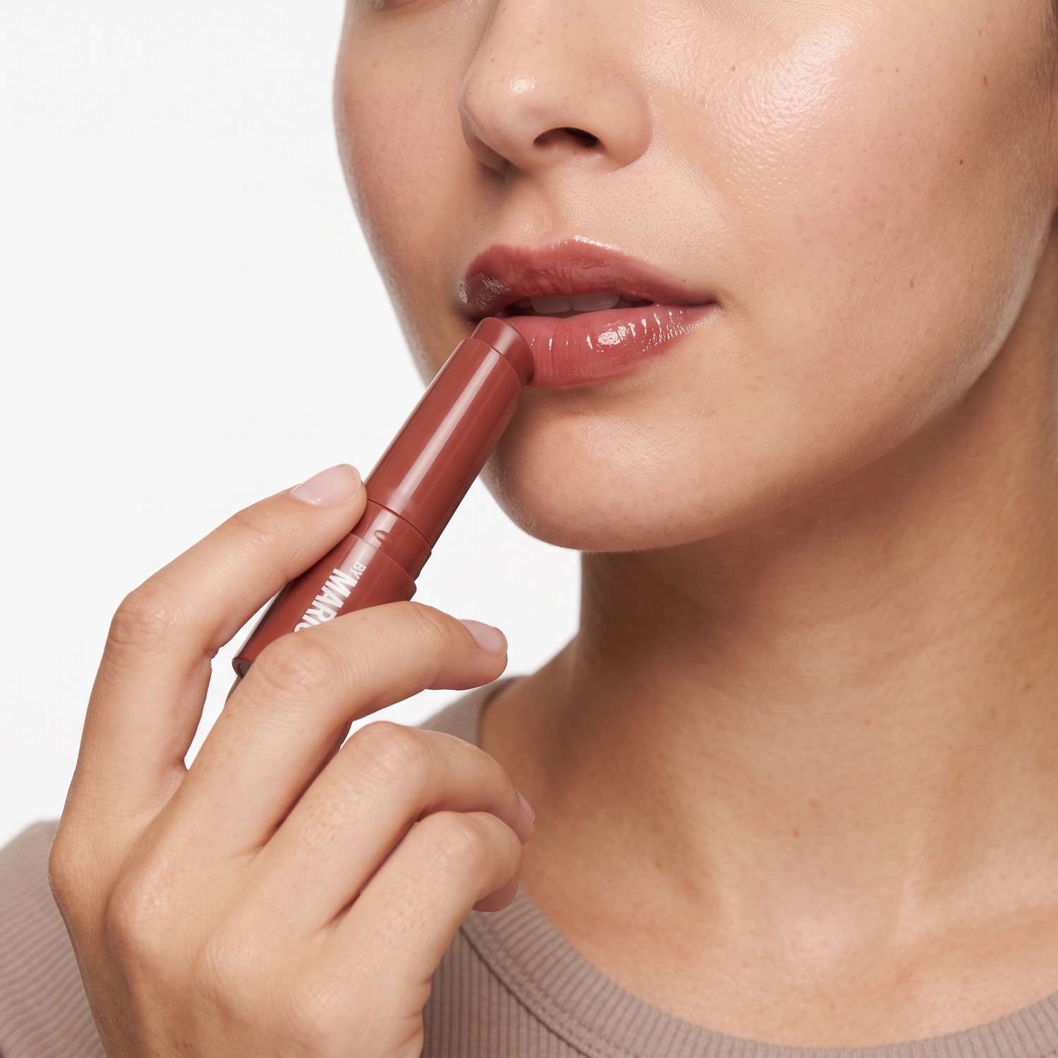 Who should try Makeup by Mario Moistureglow Lip Serum Rosewood Glow — model applying the lip stick