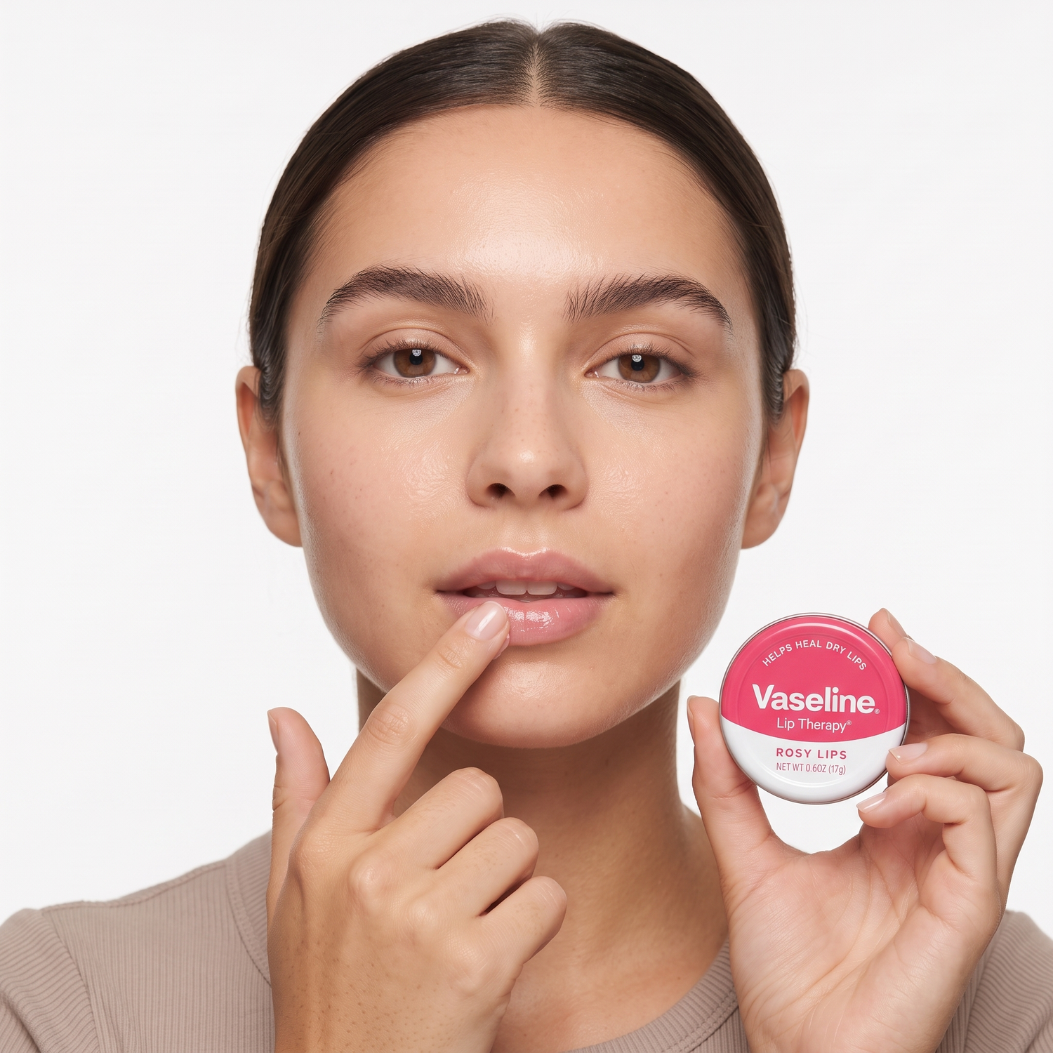 Who should try Vaseline Lip Therapy Rosy Lips — model dabbing sheer tinted lip balm